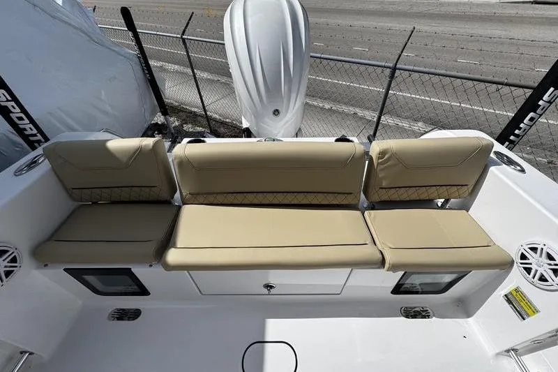 Slide: The Image of 2026 Sportsman Heritage 231 Center Console boat with beige seating and modern design. - 24