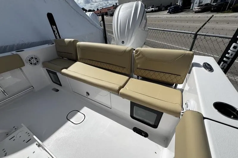 Slide: The Image of 2026 Sportsman Heritage 231 Center Console boat with tan seating and storage compartments. - 25