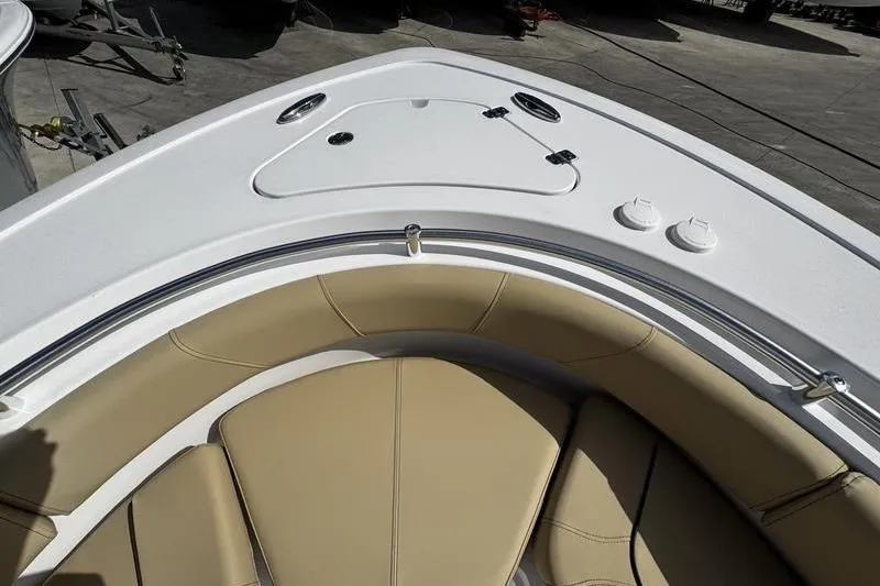 Slide: The Image of 2026 Sportsman Heritage 231 Center Console boat interior with tan seating and white deck. - 3