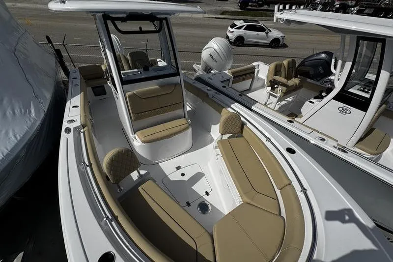 Slide: The Image of 2026 Sportsman Heritage 231 Center Console boat with tan seating and modern design. - 6
