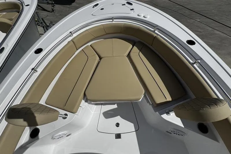 Slide: The Image of 2026 Sportsman Heritage 231 Center Console boat with tan cushioned seating. - 9