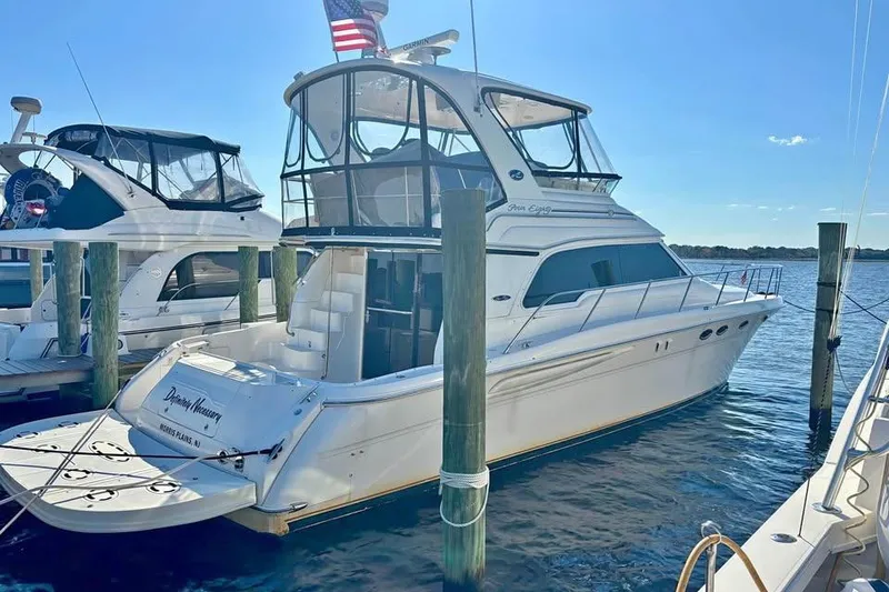 The Image of 2003 Sea Ray 480 Sedan Bridge yacht docked at marina, sunny day. - 0