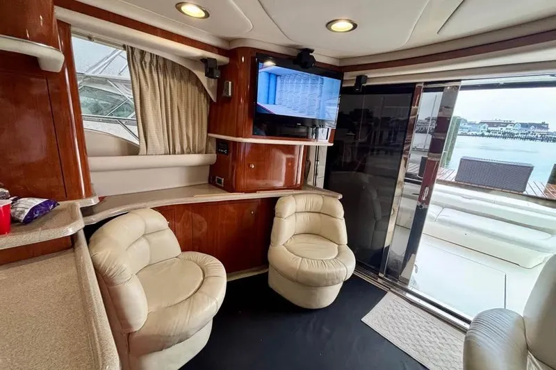 Slide: The Image of Luxurious interior of a 2003 Sea Ray 480 Sedan Bridge yacht with plush seating and a TV. - 11