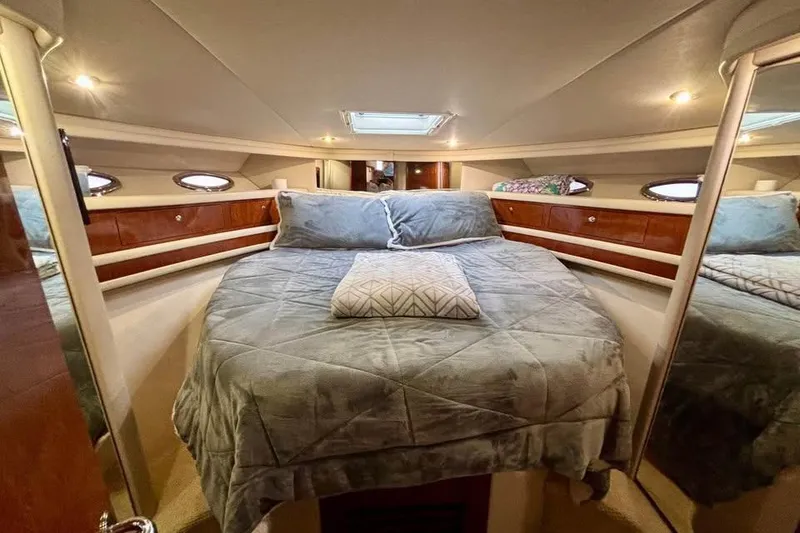 Slide: The Image of Luxurious bedroom interior of 2003 Sea Ray 480 Sedan Bridge yacht with cozy bedding. - 14