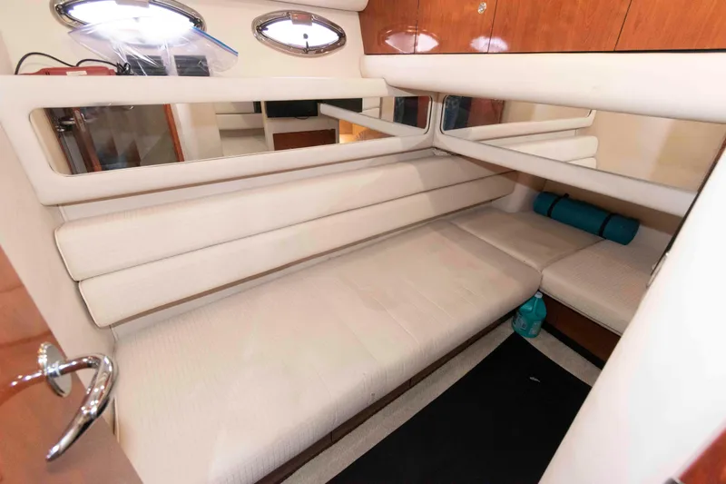 Slide: The Image of Interior cabin of 2003 Sea Ray 480 Sedan Bridge with beige seating and mirrors. - 22