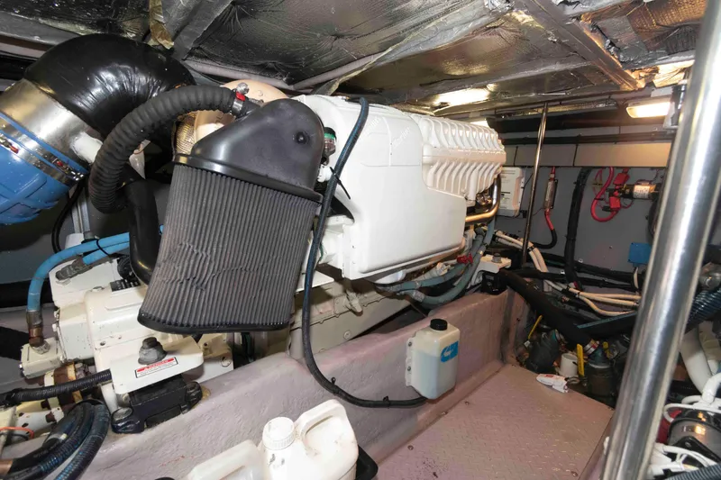 Slide: The Image of Engine room of 2003 Sea Ray 480 Sedan Bridge with visible components and wiring. - 26