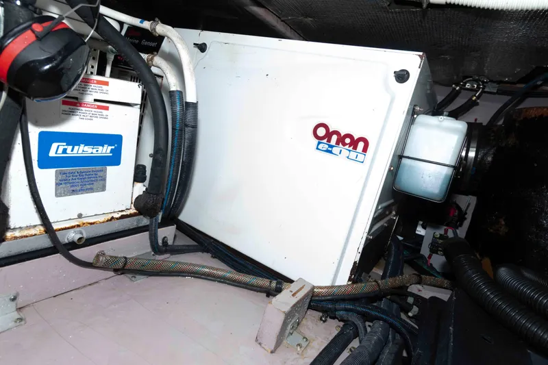 Slide: The Image of Engine room of 2003 Sea Ray 480 Sedan Bridge with Onan generator and Cruisair system. - 27