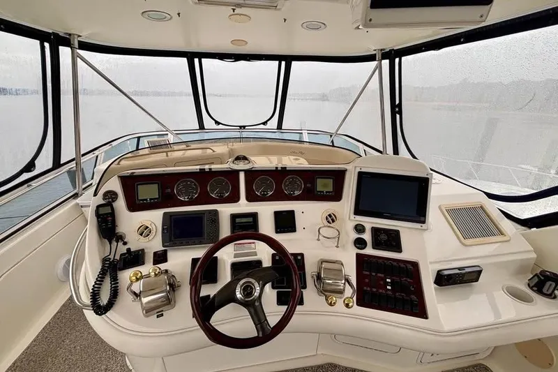 Slide: The Image of Helm of 2003 Sea Ray 480 Sedan Bridge with navigation instruments and steering wheel. - 6