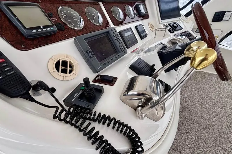 Slide: The Image of Helm of 2003 Sea Ray 480 Sedan Bridge with navigation instruments and controls. - 7