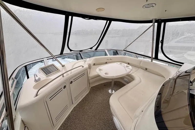 Slide: The Image of Luxurious interior of 2003 Sea Ray 480 Sedan Bridge yacht with seating and table. - 8