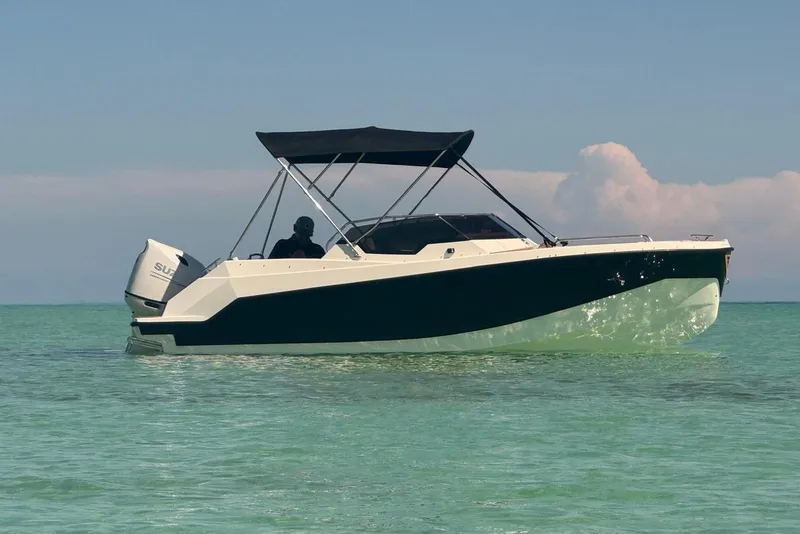 Slide: The Image of 2025 Drive Wave 570 boat cruising on clear turquoise water under a sunny sky. - 22