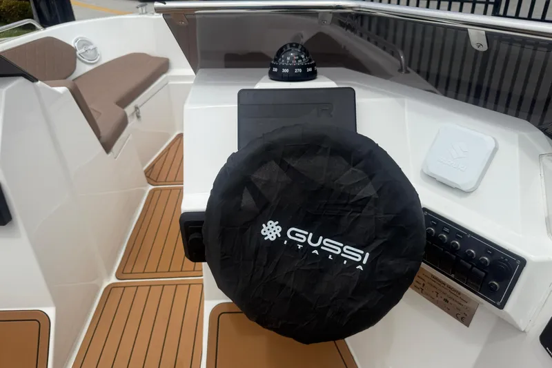 Slide: The Image of 2025 Drive Wave 570 boat cockpit with Gussi Italia steering wheel cover and compass. - 10