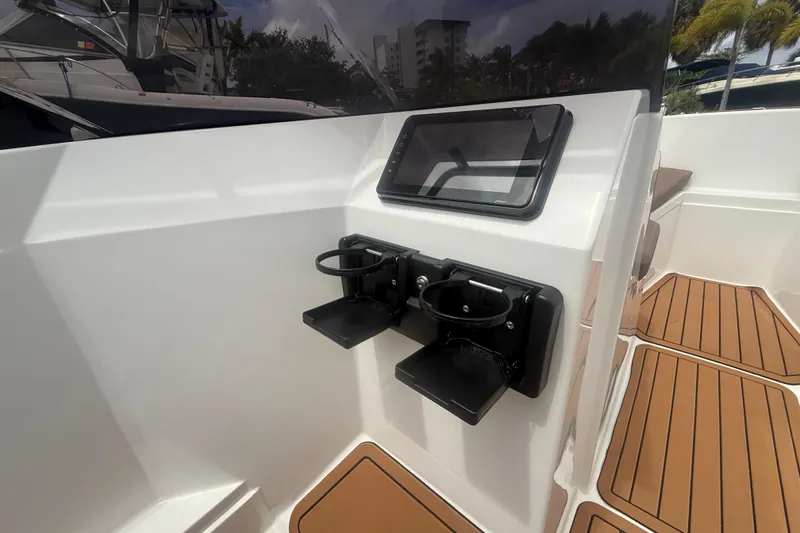 Slide: The Image of Interior of 2025 Drive Wave 570 boat with cup holders and touchscreen display. - 16
