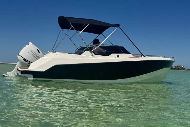 Slide: The Image of 2025 Drive Wave 570 boat with Suzuki engine on clear water. - 21