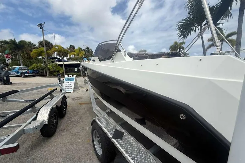 Slide: The Image of 2025 Drive Wave 570 boat on trailer, parked outdoors under cloudy sky. - 3