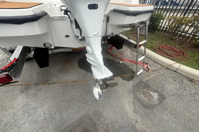 Slide: The Image of Rear view of a 2025 Drive Wave 570 boat with outboard motor and ladder. - 6