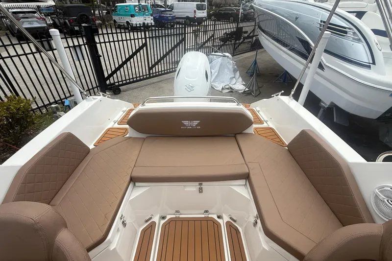 Slide: The Image of Luxurious seating area on 2025 Drive Wave 570 boat, featuring tan cushions and elegant design. - 7