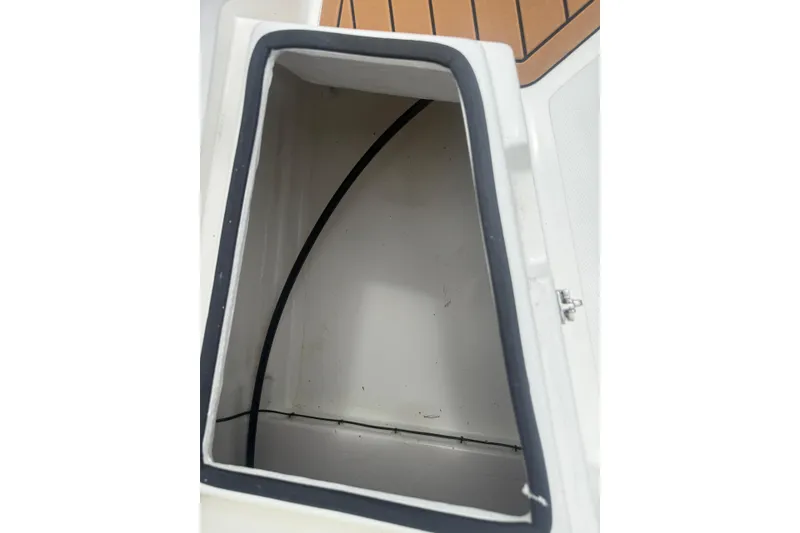 Slide: The Image of Open storage compartment on 2025 Drive Wave 570 boat, featuring sleek interior design. - 8
