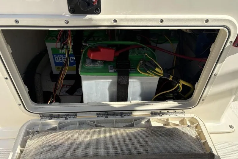 Slide: The Image of Battery compartment of a 2016 Scout 177 Sport boat, showing marine batteries and wiring. - 11