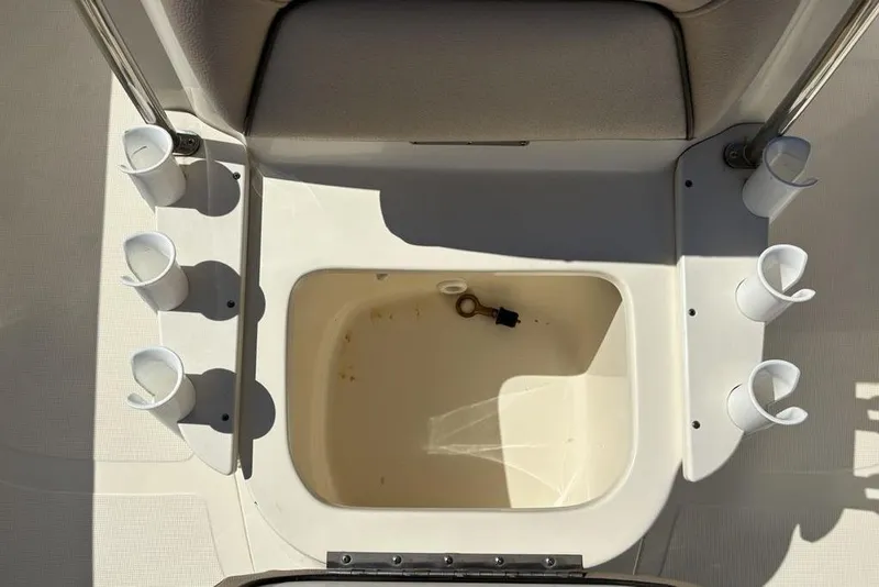 Slide: The Image of 2016 Scout 177 Sport boat interior with rod holders and storage compartment. - 13