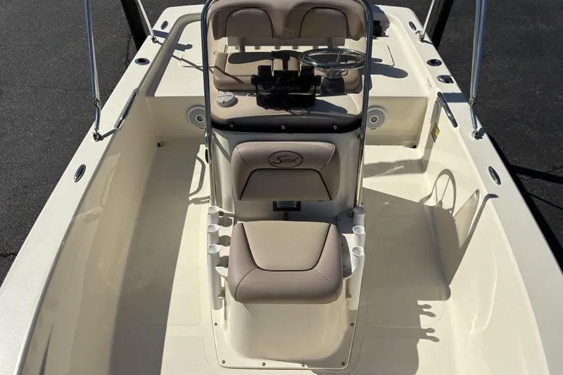 Slide: The Image of 2016 Scout 177 Sport boat interior with beige seating and steering console. - 14