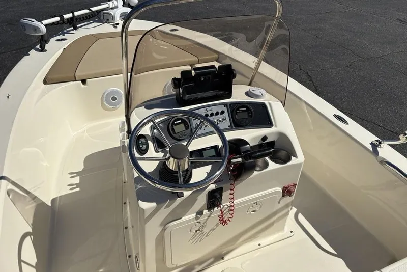 Slide: The Image of 2016 Scout 177 Sport boat cockpit with steering wheel and control panel. - 17