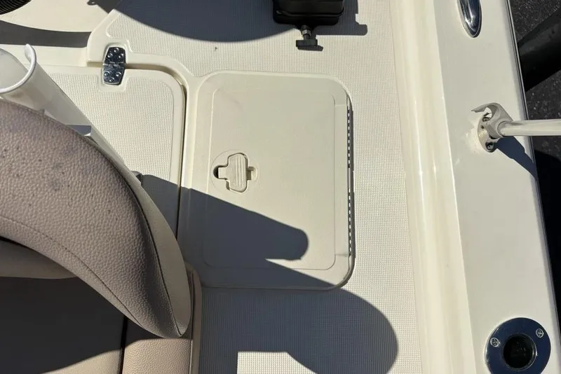 Slide: The Image of 2016 Scout 177 Sport boat deck with storage hatch and seating area. - 19