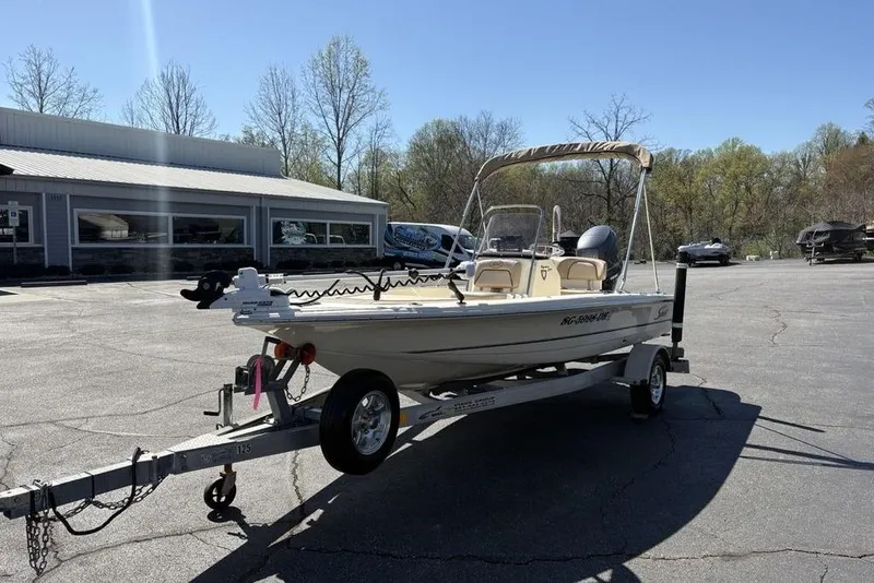 Slide: The Image of 2016 Scout 177 Sport boat on trailer in parking lot, sunny day. - 4