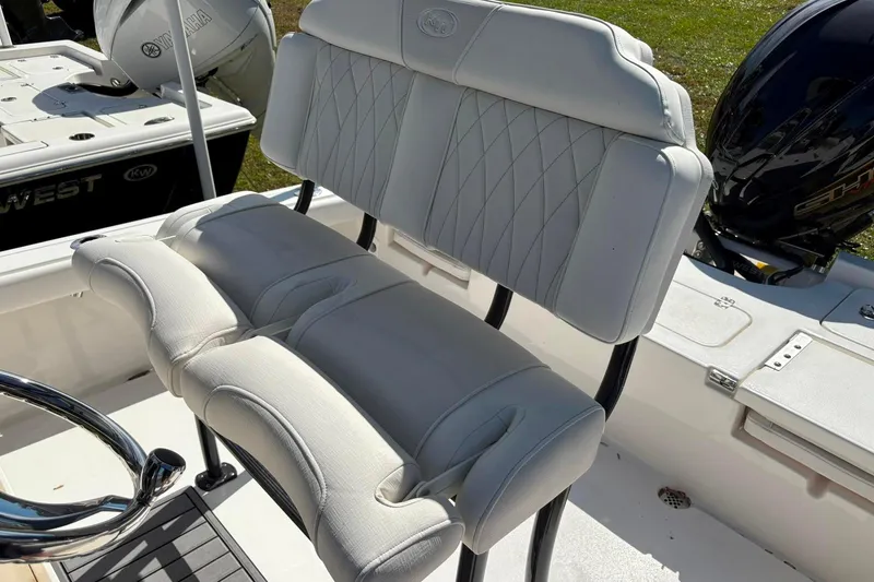 Slide: The Image of 2026 Key West 230 Bay Reef boat with white cushioned seating and Yamaha engine. - 10