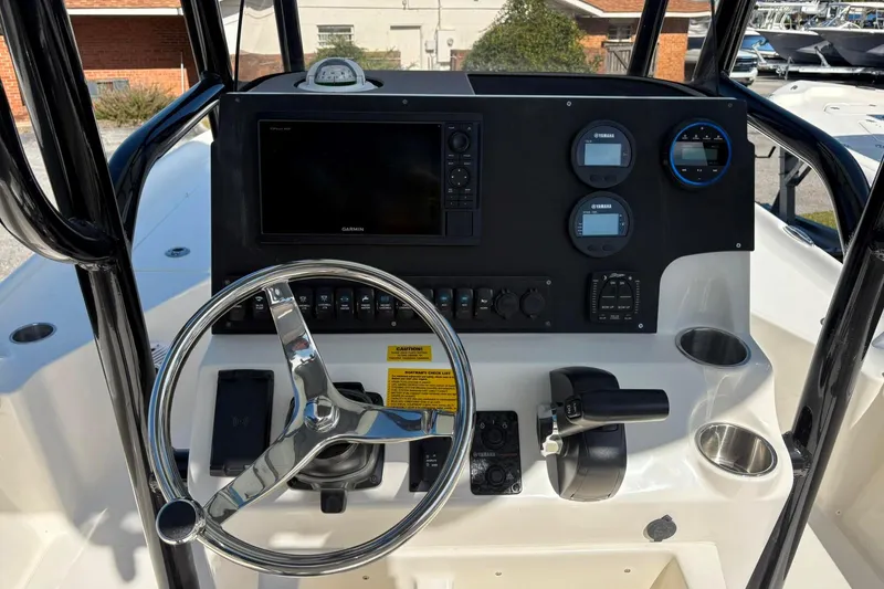 Slide: The Image of Steering console of 2026 Key West 230 Bay Reef boat with modern controls and gauges. - 2