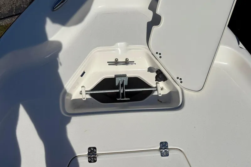 Slide: The Image of 2026 Key West 230 Bay Reef boat anchor storage compartment with open hatch. - 7