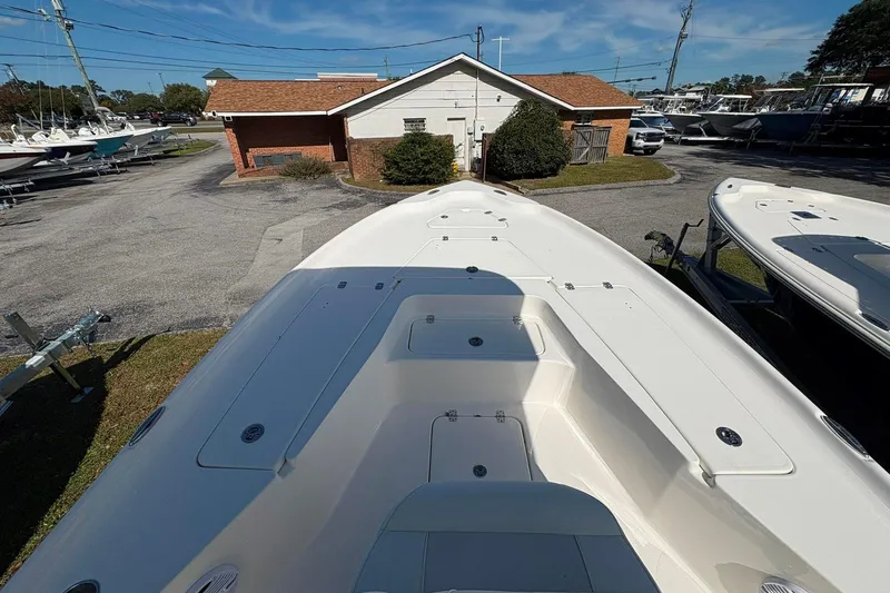 Slide: The Image of 2026 Key West 230 Bay Reef boat on display at a dealership. - 9