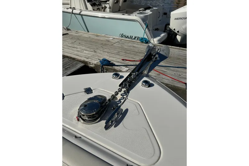 Slide: The Image of 2025 Sailfish 245 DC boat anchor and chain on deck by dock. - 11
