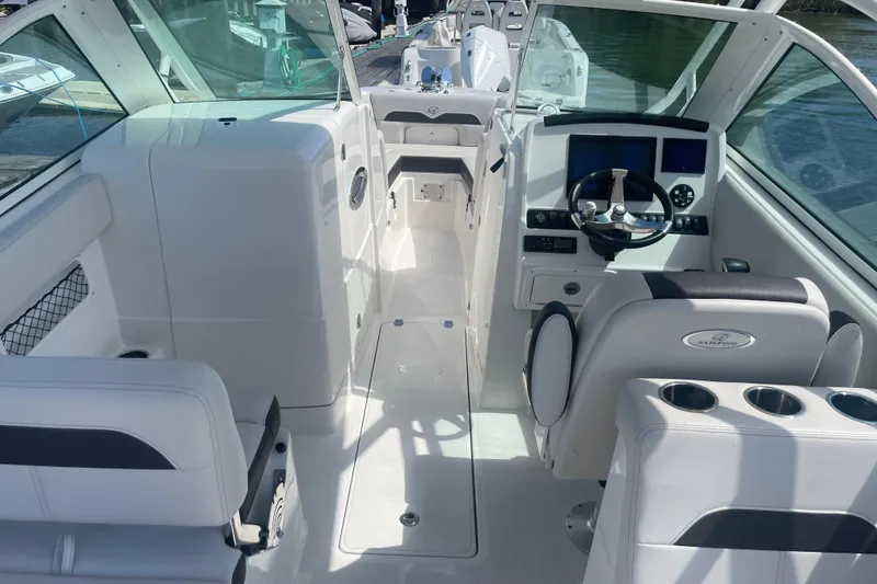 Slide: The Image of 2025 Sailfish 245 DC boat interior with modern helm, seating, and cup holders. - 4