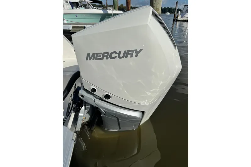 Slide: The Image of Mercury outboard motor on 2025 Sailfish 245 DC boat, docked in marina. - 7
