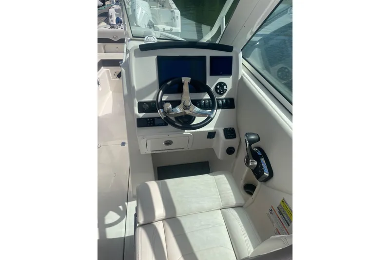Slide: The Image of Helm of 2025 Sailfish 245 DC boat with modern controls and steering wheel. - 5