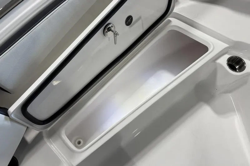 Slide: The Image of Storage compartment of 2026 Tidewater 210 CC Adventure boat, featuring secure lock and sleek design. - 12