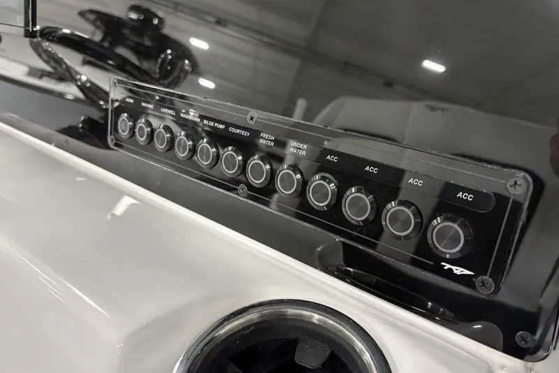 Slide: The Image of Control panel of 2026 Tidewater 210 CC Adventure boat with labeled switches. - 13