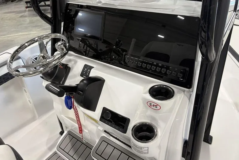 Slide: The Image of 2026 Tidewater 210 CC Adventure boat console with steering wheel and controls. - 14