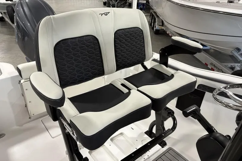 Slide: The Image of 2026 Tidewater 210 CC Adventure boat seats with black and white upholstery. - 15