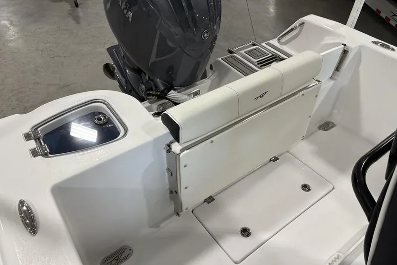 Slide: The Image of 2026 Tidewater 210 CC Adventure boat interior with seating and engine detail. - 19