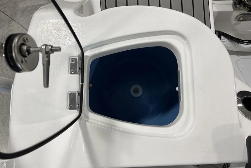 Slide: The Image of Livewell compartment on 2026 Tidewater 210 CC Adventure boat, featuring a blue interior. - 21