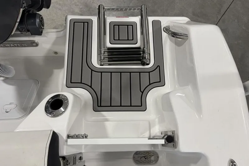 Slide: The Image of 2026 Tidewater 210 CC Adventure boat deck with foldable ladder and sleek design. - 23