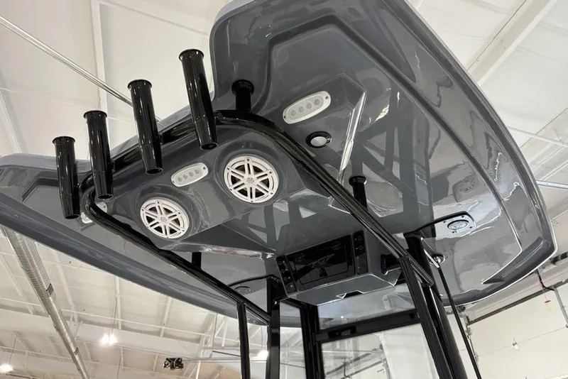 Slide: The Image of 2026 Tidewater 210 CC Adventure boat T-top with rod holders and speakers. - 24