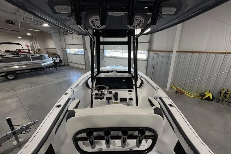 Slide: The Image of 2026 Tidewater 210 CC Adventure boat interior in a spacious garage setting. - 26