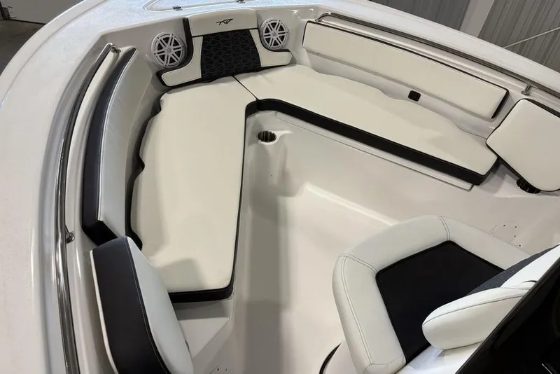 Slide: The Image of 2026 Tidewater 210 CC Adventure boat interior with white seating and speakers. - 4