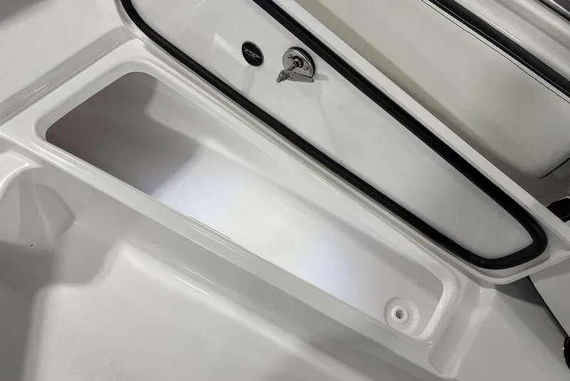 Slide: The Image of Storage compartment of 2026 Tidewater 210 CC Adventure boat, featuring sleek design and secure latch. - 5