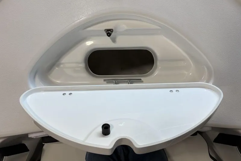 Slide: The Image of Storage compartment on 2026 Tidewater 210 CC Adventure boat, featuring a white lid and black handle. - 6