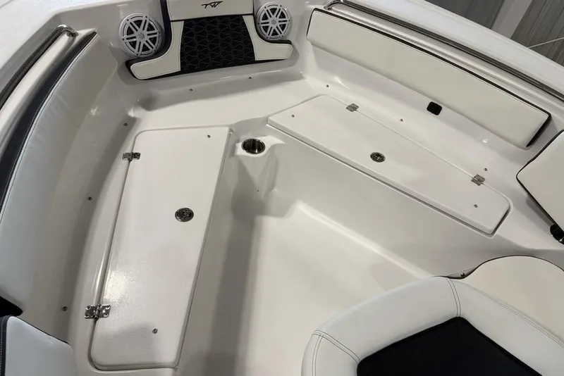Slide: The Image of 2026 Tidewater 210 CC Adventure boat interior with white seating and storage compartments. - 9