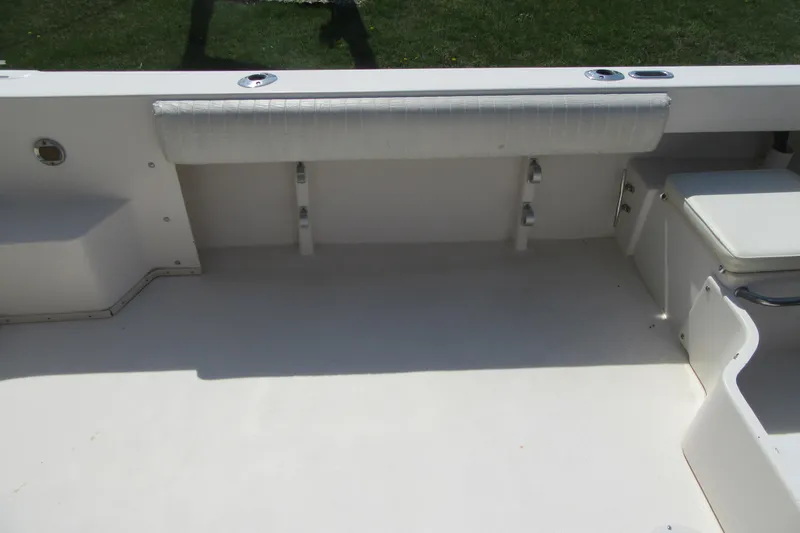 Slide: The Image of 2006 Parker 2120 Sport Cabin boat interior with seating and storage compartments. - 10